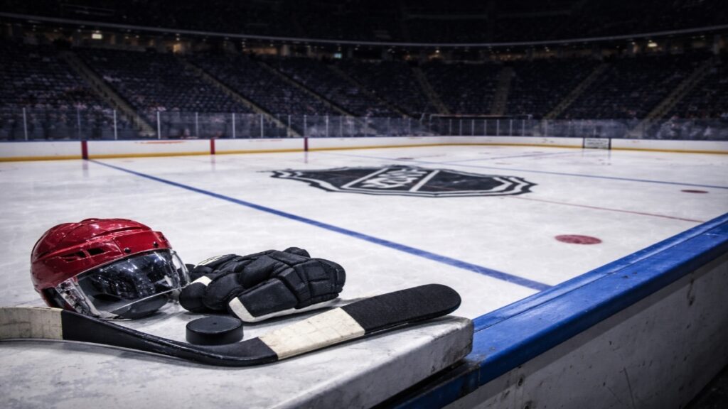 Empty NHL arena in Canada during Winter Olympics break with hockey equipment on the bench